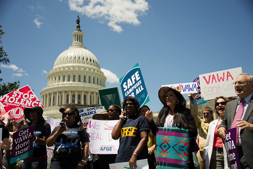 People hold a rally for the reauthorization of the Violence Against Women Act, outside the U.S. Capitol in Washington, June 2012. (Getty/Jim Watson)
