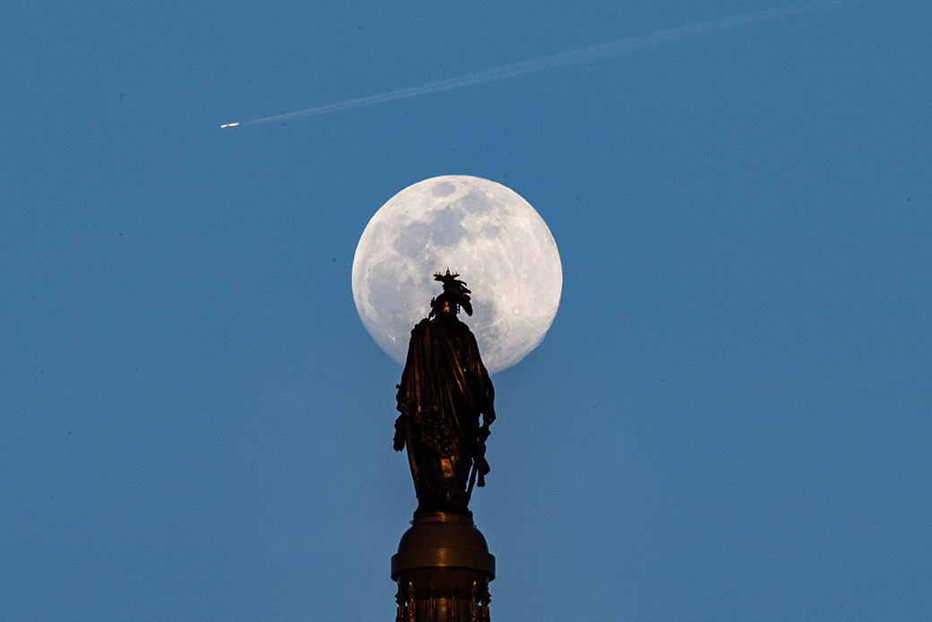 The Worm Moon rises behind the Statue of Freedom on top of the dome of the U.S. Capitol, March 2019. (Getty/Jonathan Newton)