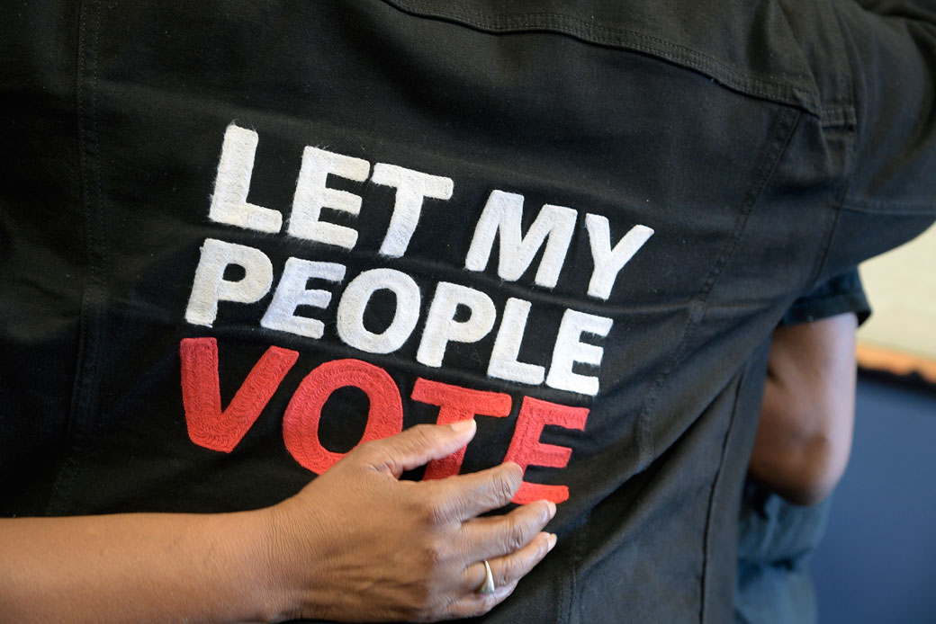 A formerly incarcerated man is hugged by a friend after registering to vote inside the Orange County Supervisor of Elections office in Orlando, Florida, on January 8, 2019. (Getty/The Washington Post/Phelan M. Ebenhack)