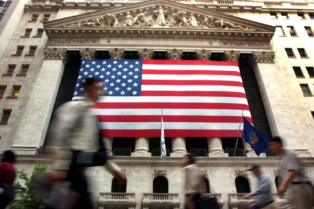 Pedestrians walk past the New York Stock Exchange in New York City, July 2002. (Getty/Spencer Platt)