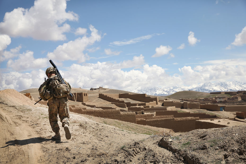 A U.S. soldier patrols on the edge of a village near Pul-e Alam, Afghanistan, March 2014.