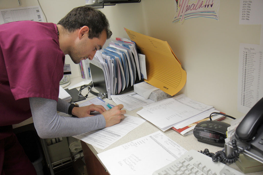 A man fills out a form in the doctor's office at Mount Sinai Medical Center, December 2009. (Getty/Jeffrey Greenberg/Universal Images)