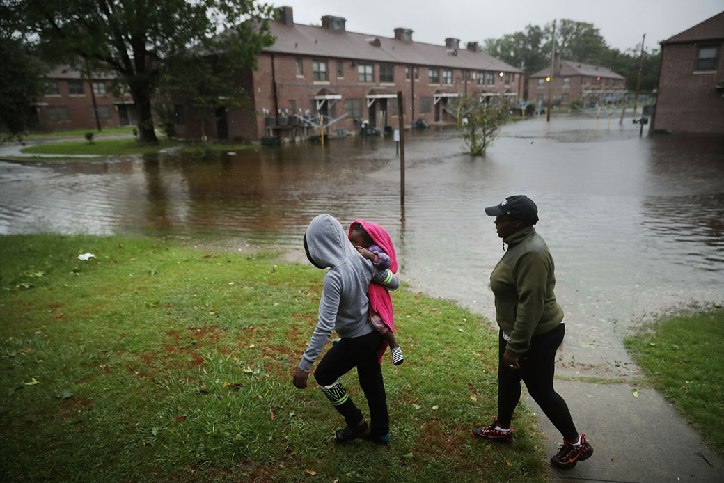 Residents survey the flooding at the Trent Court public housing complex in New Bern, North Carolina, following Hurricane Florence, September 2018.
