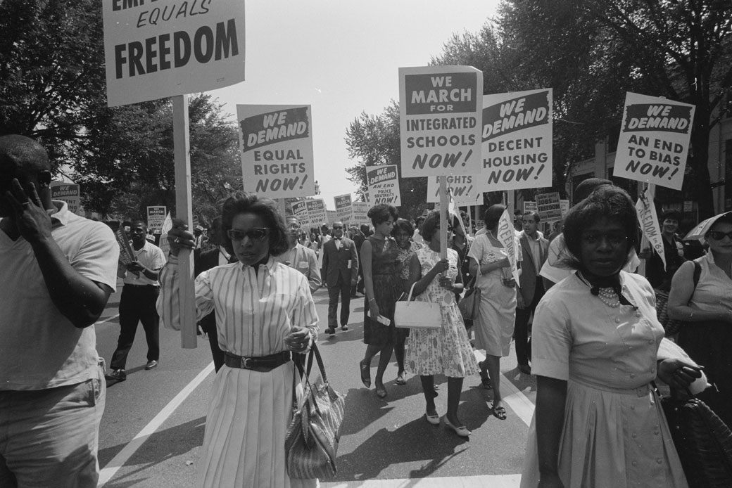 Civil rights advocates carry placards during the March on Washington for Jobs and Freedom on August 28, 1963, in Washington, D.C. (Getty/Universal History Archive/Warren K. Leffler)