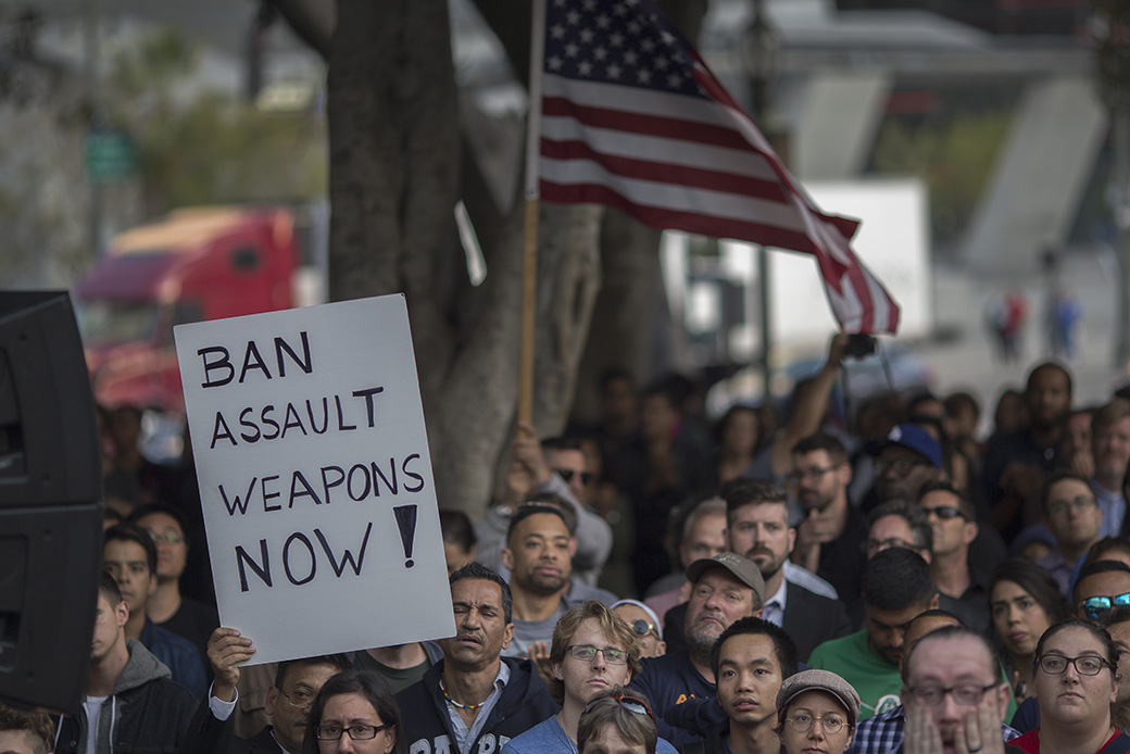 A sign calling for a ban on assault weapons is held at a vigil in Los Angeles for the Pulse nightclub shooting, June 2016. (Getty/David McNew)