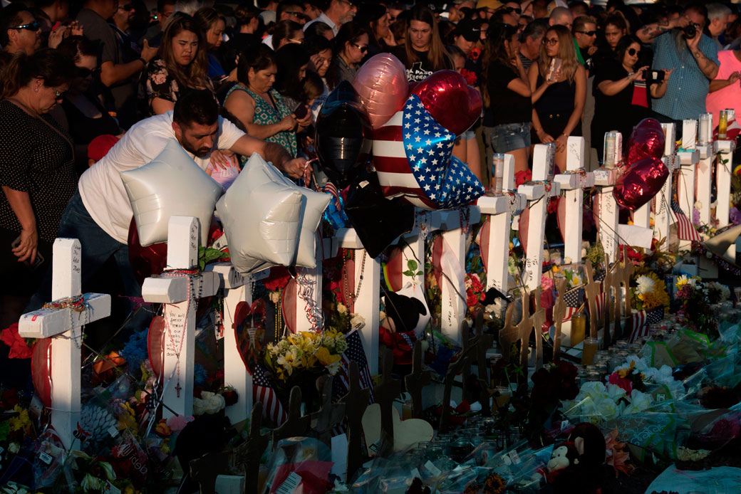 People pay their respects at the makeshift memorial for victims of the shooting that left a total of 22 people dead in El Paso, August 2019. (Getty/Mark Ralston)