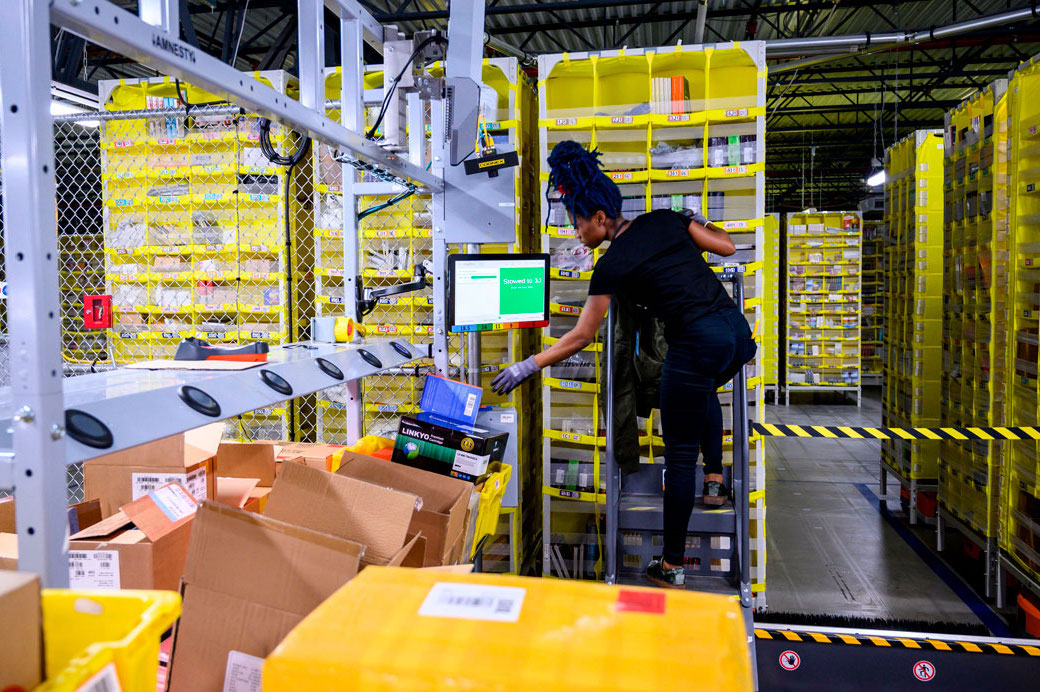 A woman works at a distribution station in Staten Island, New York, February 2019. (Getty/Johannes Eisle/AFP)