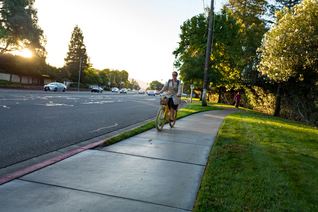 (A woman rides her bike on the way to work in the morning in California.)