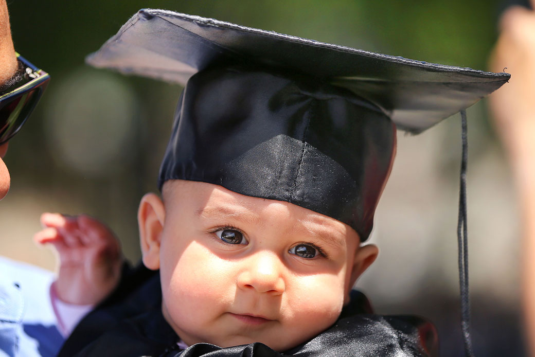 A baby attends his mother's graduation ceremony at the Massachusetts Institute of Technology in Cambridge, Massachusetts, June 2017. (Getty/John Tlumacki)