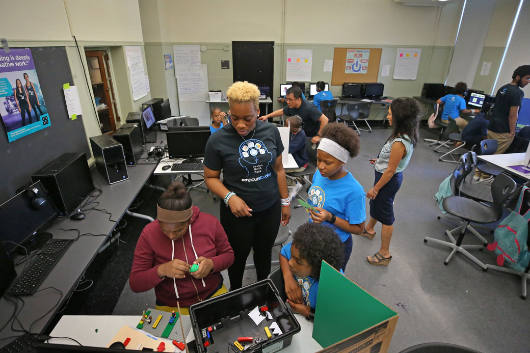 A teacher helps students work with a 3D printer during a summer learning program in Boston, August 2017. (Getty/David L. Ryan/The Boston Globe)