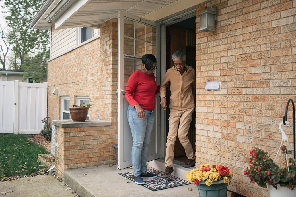  (A woman walks out of her home with her mother in Illinois.)