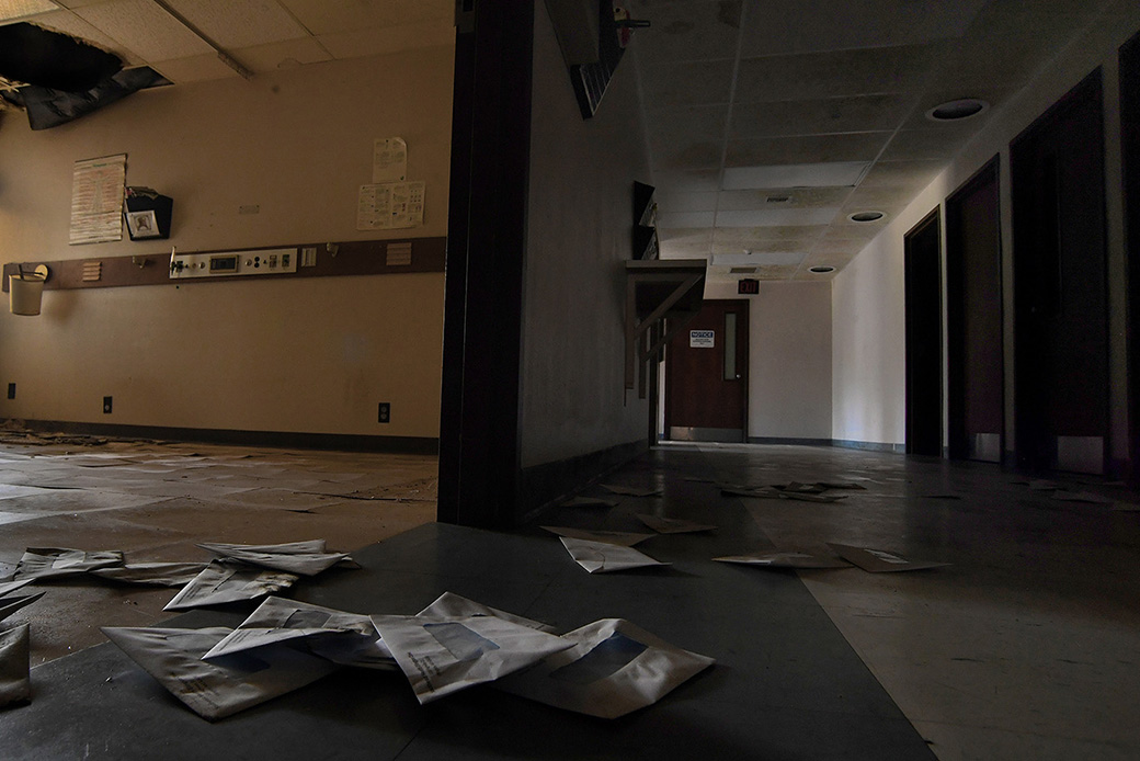 ELLINGTON, MO-JULY 19: Billing envelopes litter the floor of the shuttered Southeast Health Center
in Ellington, Missouri on July 19, 2019. The rural hospital closed in March of 2016 and was $17 million in debt. Many locals fear that the trip to the Poplar Bluff Regional Medical Center, an hour away, would pose health risks if they needed immediate hospital care. The Poplar Bluff area in southeast Missouri is a part of the country where both healthcare providers and medical care recipients have been burdened by medical related costs. There are scores of people in the area who are being sued by the local hospital for medical bills they cannot pay. The hospital feels it has no choice but to pursue the cases as rural patients are visiting the emergency room in record numbers and increasingly defaulting on their bills. (Photo by Michael S. Williamson/The Washington Post via Getty Images)