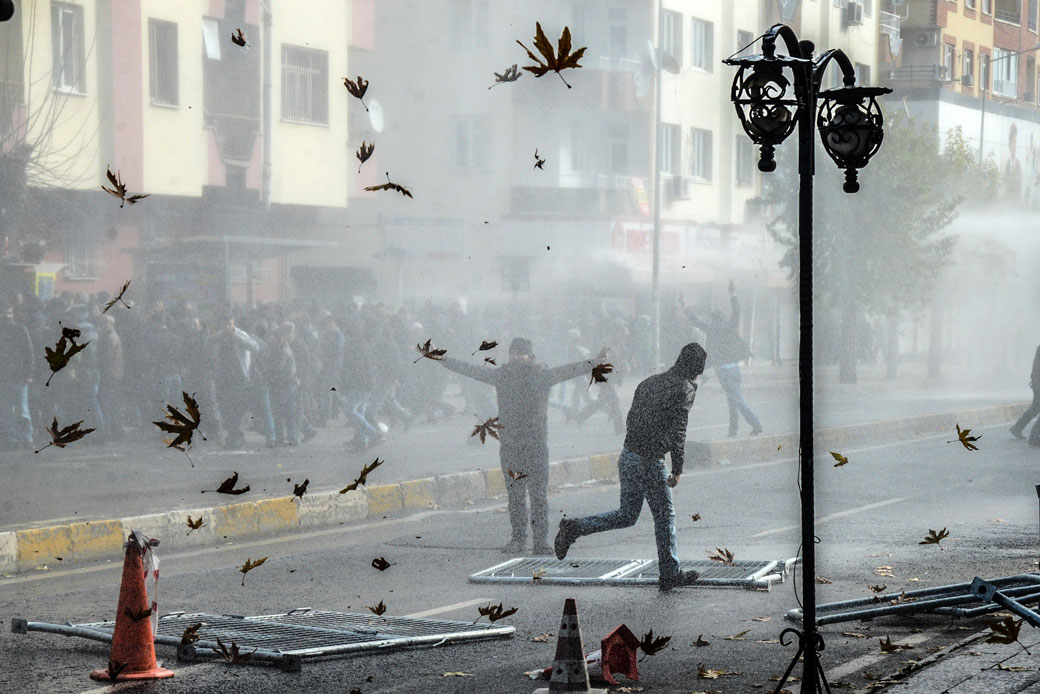 Kurds clash with the Turkish police as they protest against recent curfews imposed on December 14, 2015, in downtown Diyarbakır. (Getty/AFP/Ilyas Akengin)
