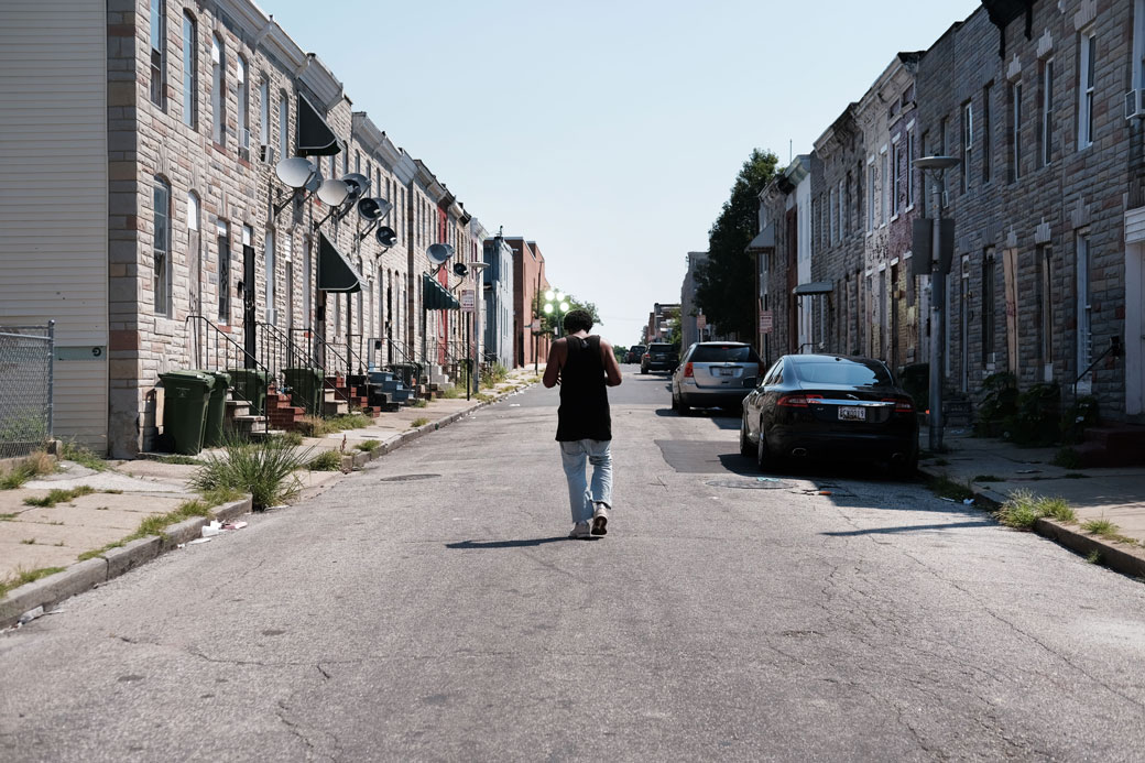 A man walks down a street in Baltimore, July 2019. (Getty/Spencer Platt)