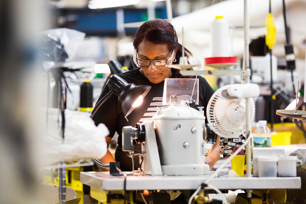  (A worker operates machinery at a factory in Lawrence, Massachusetts, July 2017.)