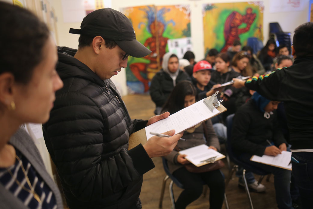 Immigrants fill out forms for DACA at a February 2015 workshop in New York City. (Getty/John Moore)