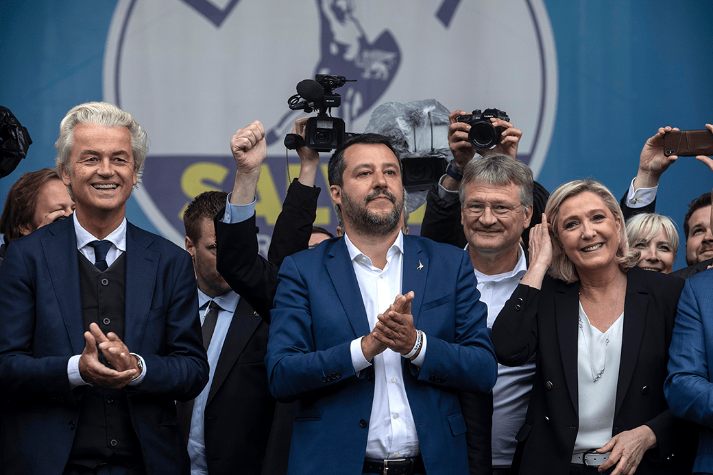  (Four leaders of right-wing European populist parties (Geert Wilders of the Netherlands, Matteo Salvini of Italy, Jörg Meuthen of Germany, and Marine Le Pen of France) are pictured clapping and smiling at a rally.)