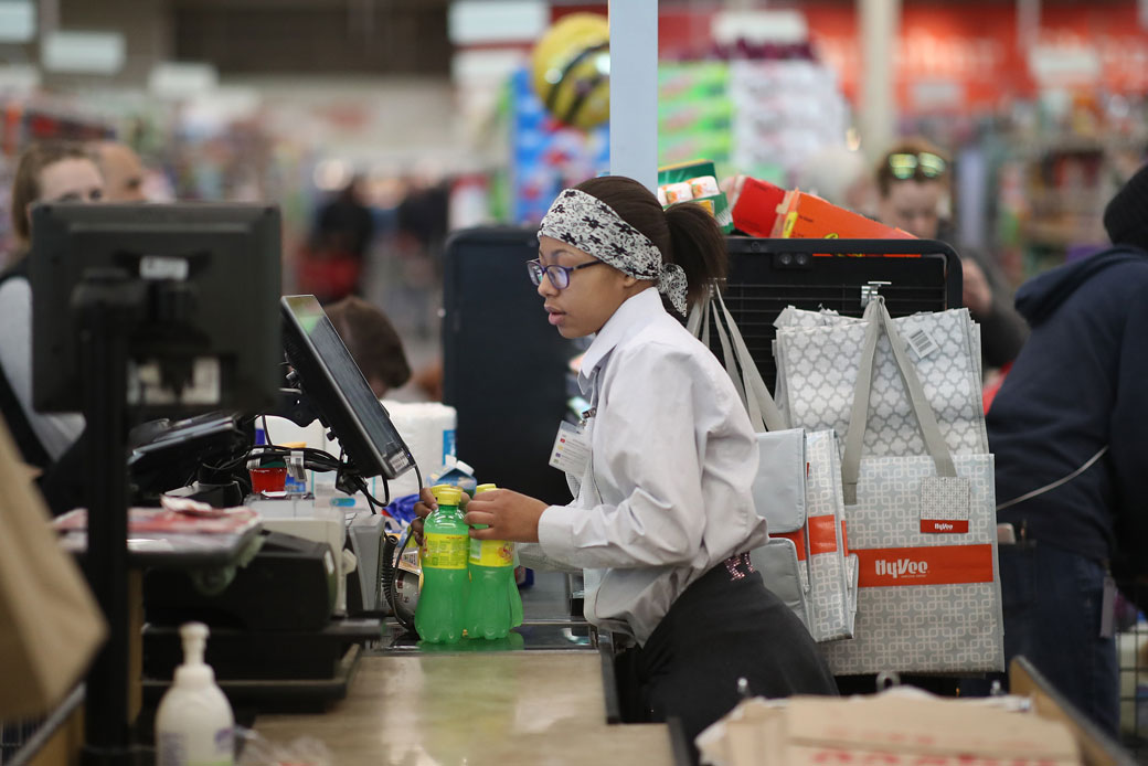 A cashier helps a customer at a grocery store in New Hope, Minnesota, February 2018. (Getty/Jerry Holt)