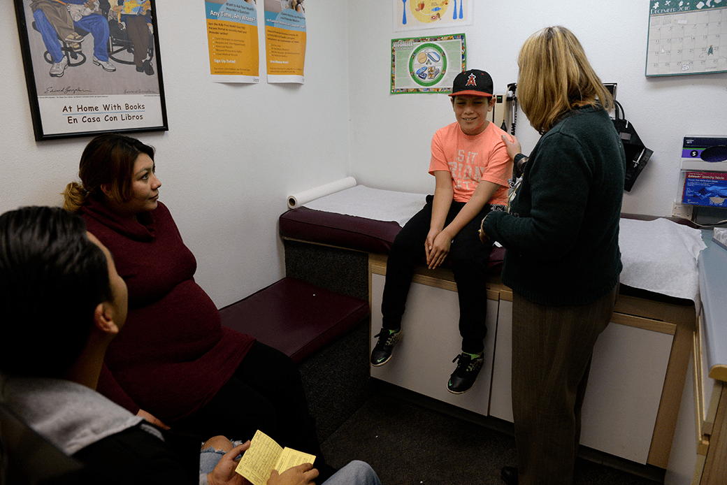A nurse practitioner speaks with a patient at a nonprofit children's health clinic that provides affordable care in Commerce City, Colorado, December 2016. (Getty/Kathryn Scott)