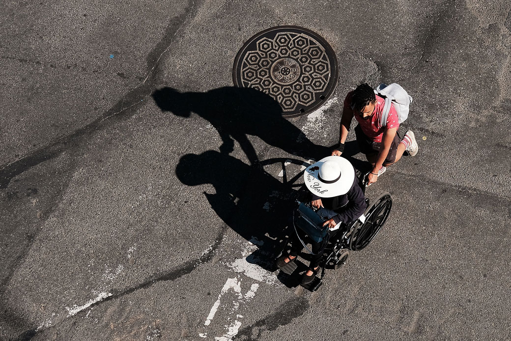 A man pushes a woman in a wheelchair up to the High Line in New York City, June 2018. (Getty/Spencer Platt)