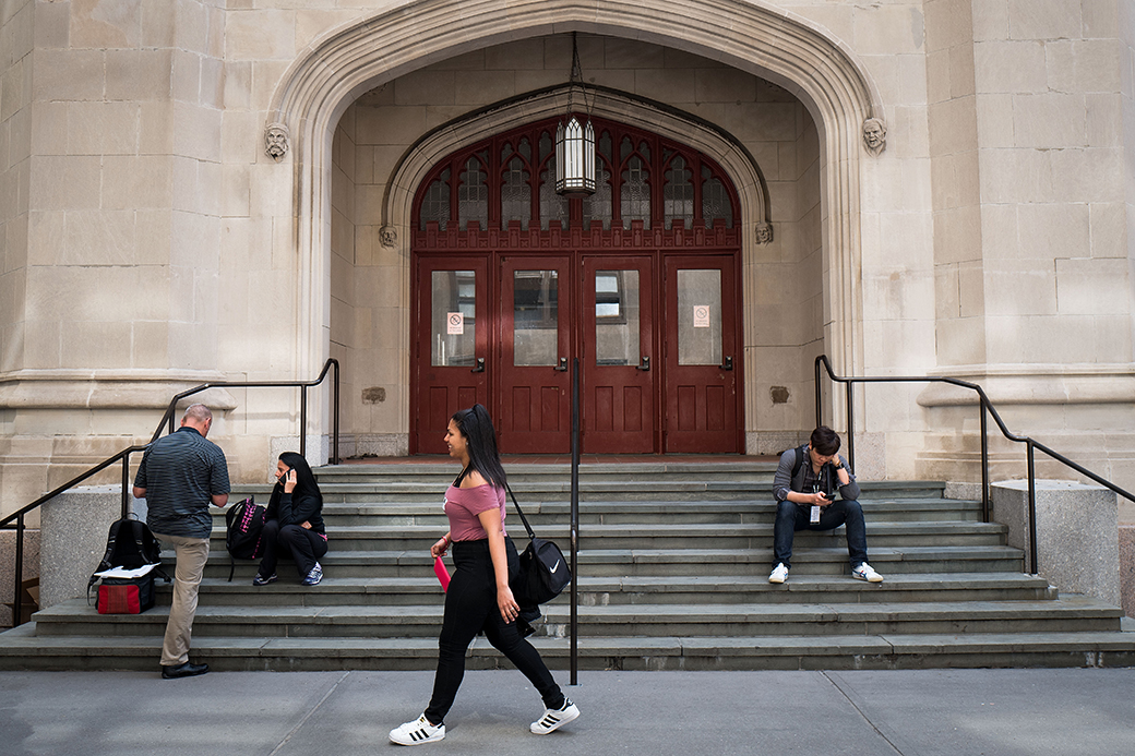 People and students mill about on a New York City college campus, April 2017. (Getty/Drew Angerer)