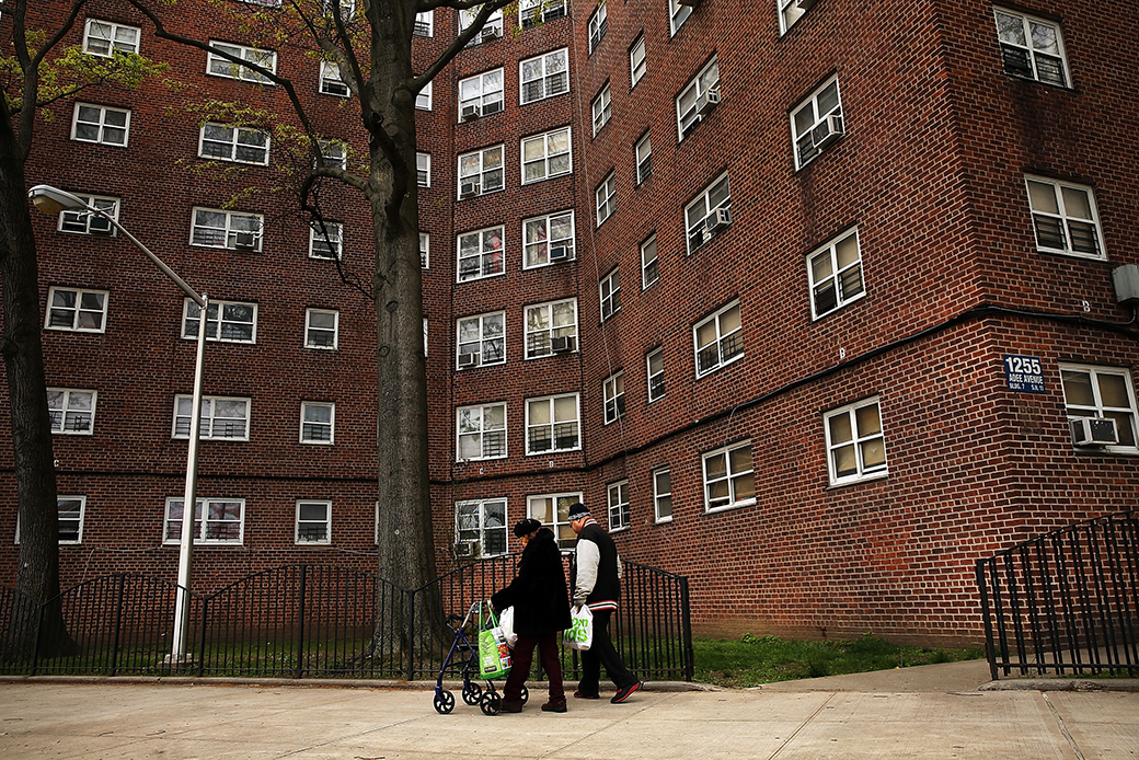 Residents walk through a housing complex in the Bronx, April 2016, in New York. (Residents walk through a New York housing complex.)