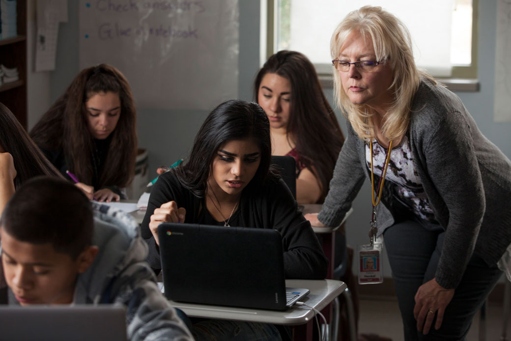  (A teacher helps a student who is reviewing for a geometry final in a Greeley, Colorado, high school, December 2016.)