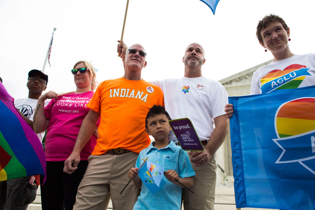 A boy stands with his two fathers in front of the U.S. Supreme Court in Washington, D.C., on June 26, 2015. (Getty/The Washington Post/Brittany Greeson)