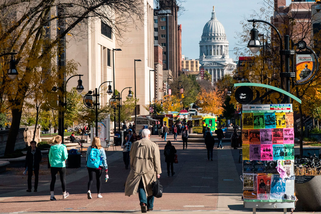 People walk toward the Wisconsin state Capitol building in Madison, October 2017. (People walk toward the Wisconsin state Capitol building in Madison, October 2017.)