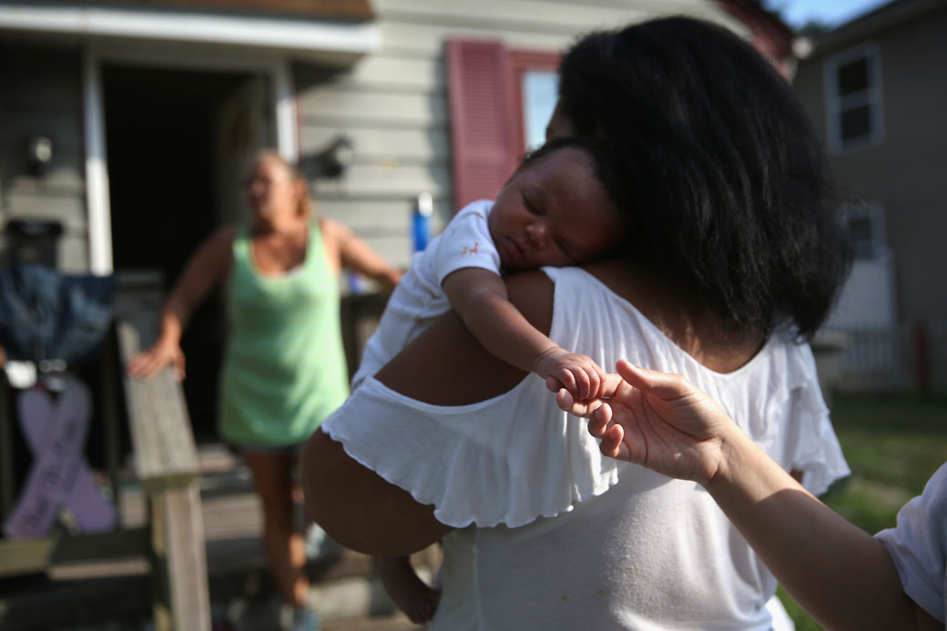 A grandmother arrives with her grandchild at a friend's home in Atlantic City, New Jersey, August 2015. (Getty/John Moore)