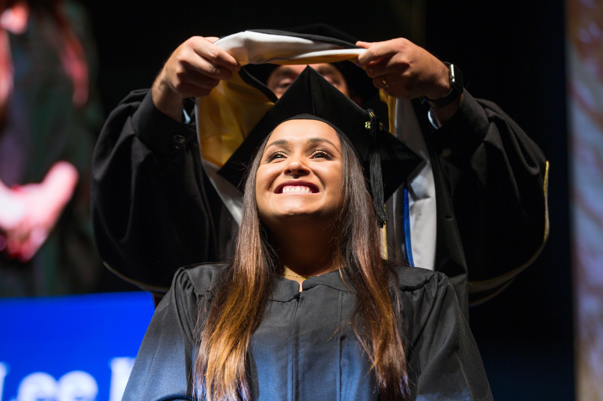 A woman receives her masters degree hood during her university's fall commencement in San Jose, California, on Wednesday, December 19, 2018. (Getty/Randy Vazquez)