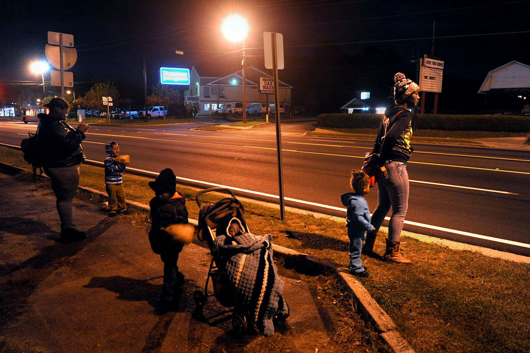 Two women who have been living in homeless shelters after struggling to find jobs that would cover the cost of child care wait with their children for the bus in Atlanta, December 2015. (Getty/Michael S. Williamson/The Washington Post)