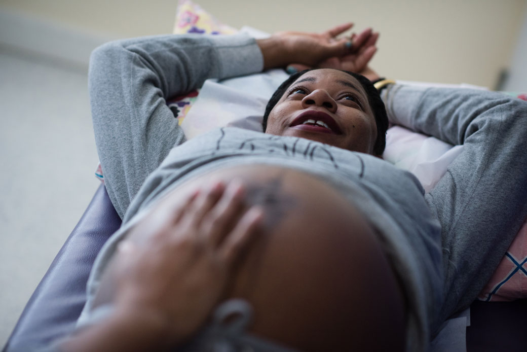 A midwife at a family health and birth center in Washington, D.C., examines an expectant mother, February 2018.
