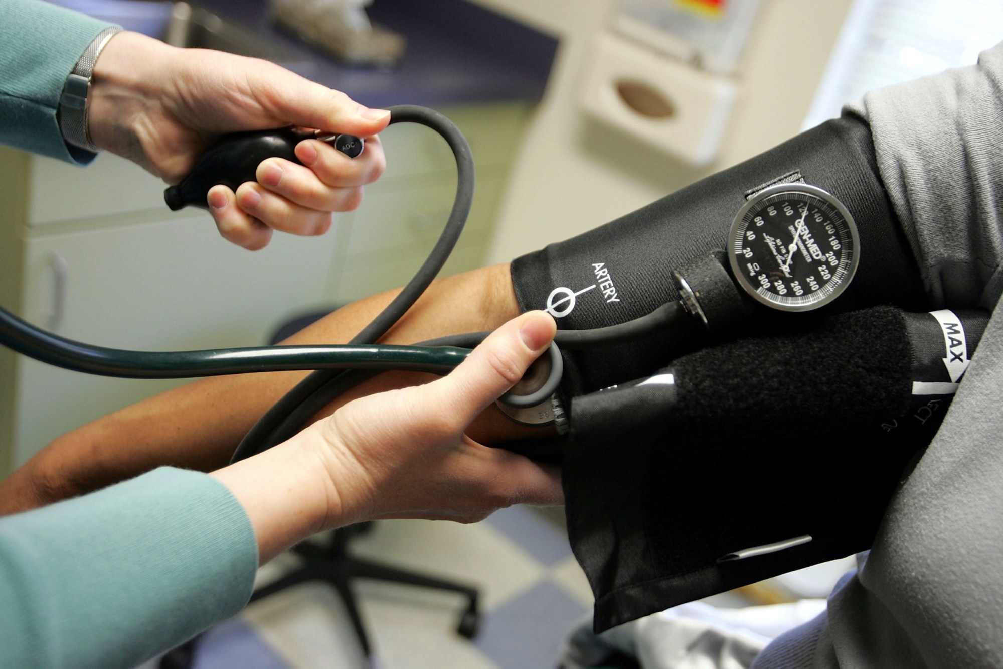 Dr. Elizabeth Maziarka reads a blood pressure gauge during an examination of patient June Mendez at the Codman Square Health Center in Dorchester, Massachusetts on April 11, 2006. (Getty/Joe Raedle)