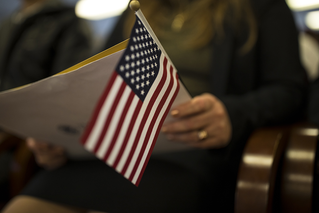 A newly sworn-in U.S. citizen holds an American flag at a naturalization ceremony for new U.S. citizens in Newark, New Jersey, February 2017. (Getty/Robert Nickelsberg)