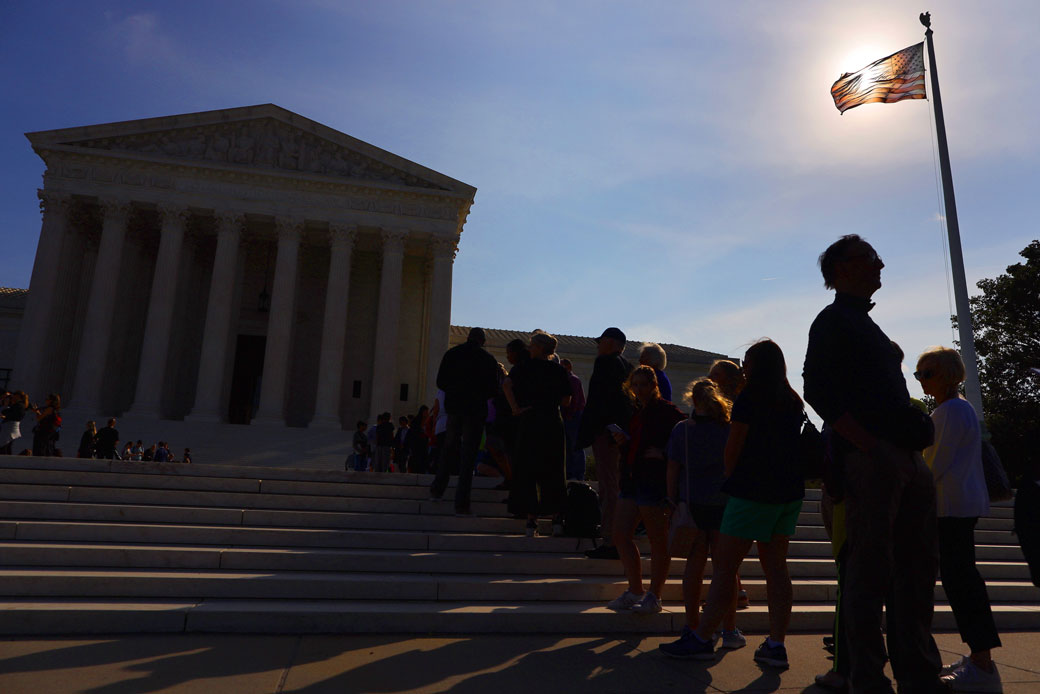 Hundreds of people line up outside of the U.S. Supreme Court building for a chance to attend arguments at the start of the court's new term, October 7, 2019, in Washington, D.C. (Hundreds wait in line outside of Supreme Court.)