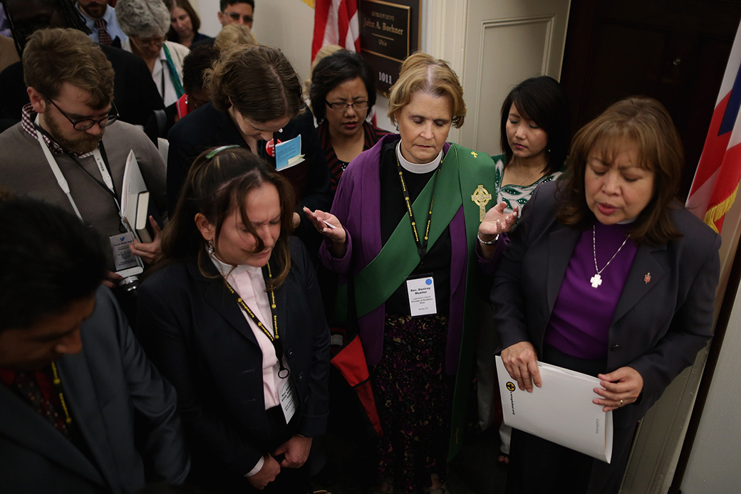 Bishop Minerva Carcaño (R) and other faith leaders and lay people join in prayer outside the constituent office of then-Speaker of the House John Boehner (R-OH) while lobbying for immigration reform, October 8, 2013, in Washington, D.C. (Getty/Chip Somodevilla)
