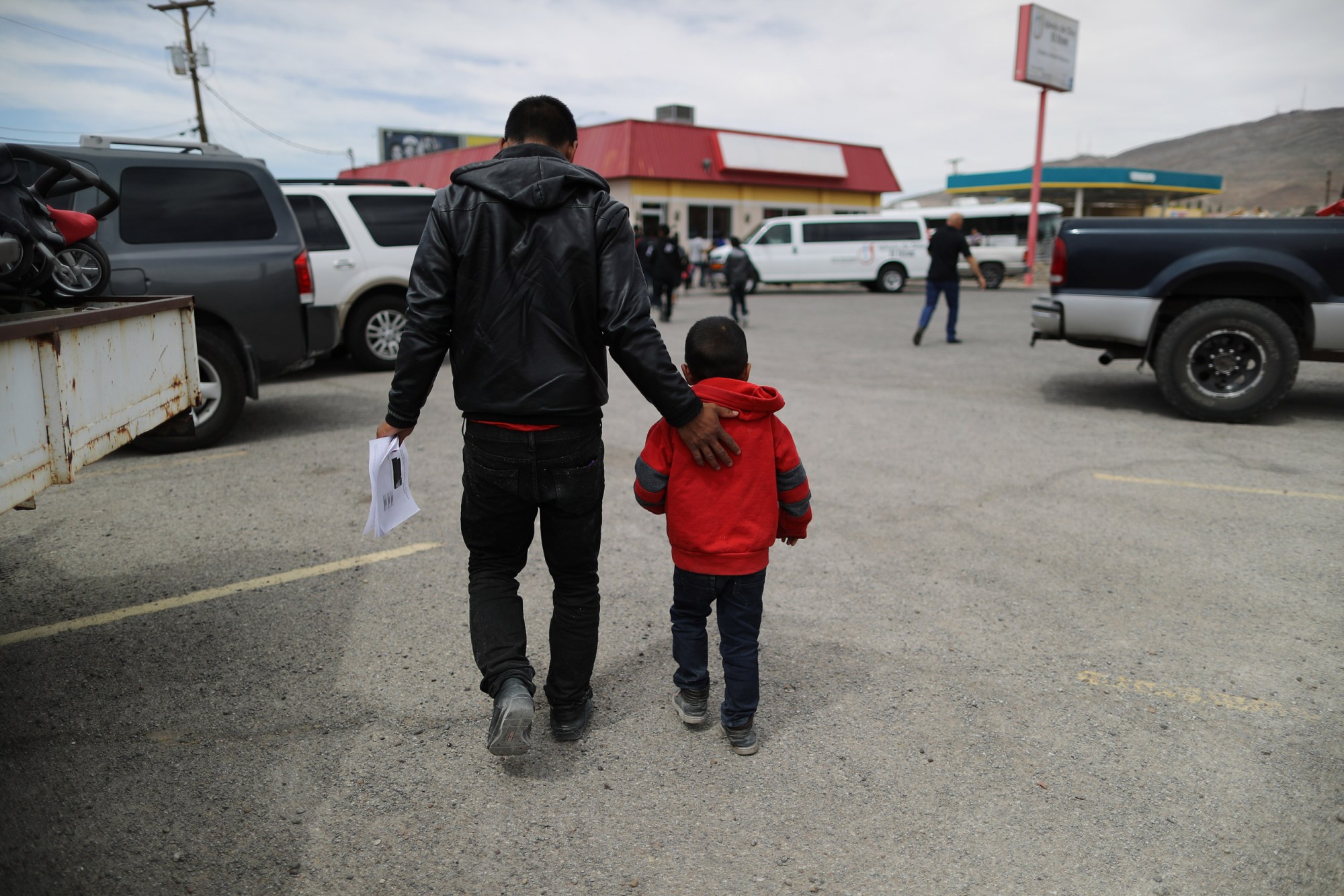 A migrant carries his ICE paperwork after being dropped off at a church serving as a shelter for migrants who are seeking asylum, May 2019. (Getty/Mario Tama)