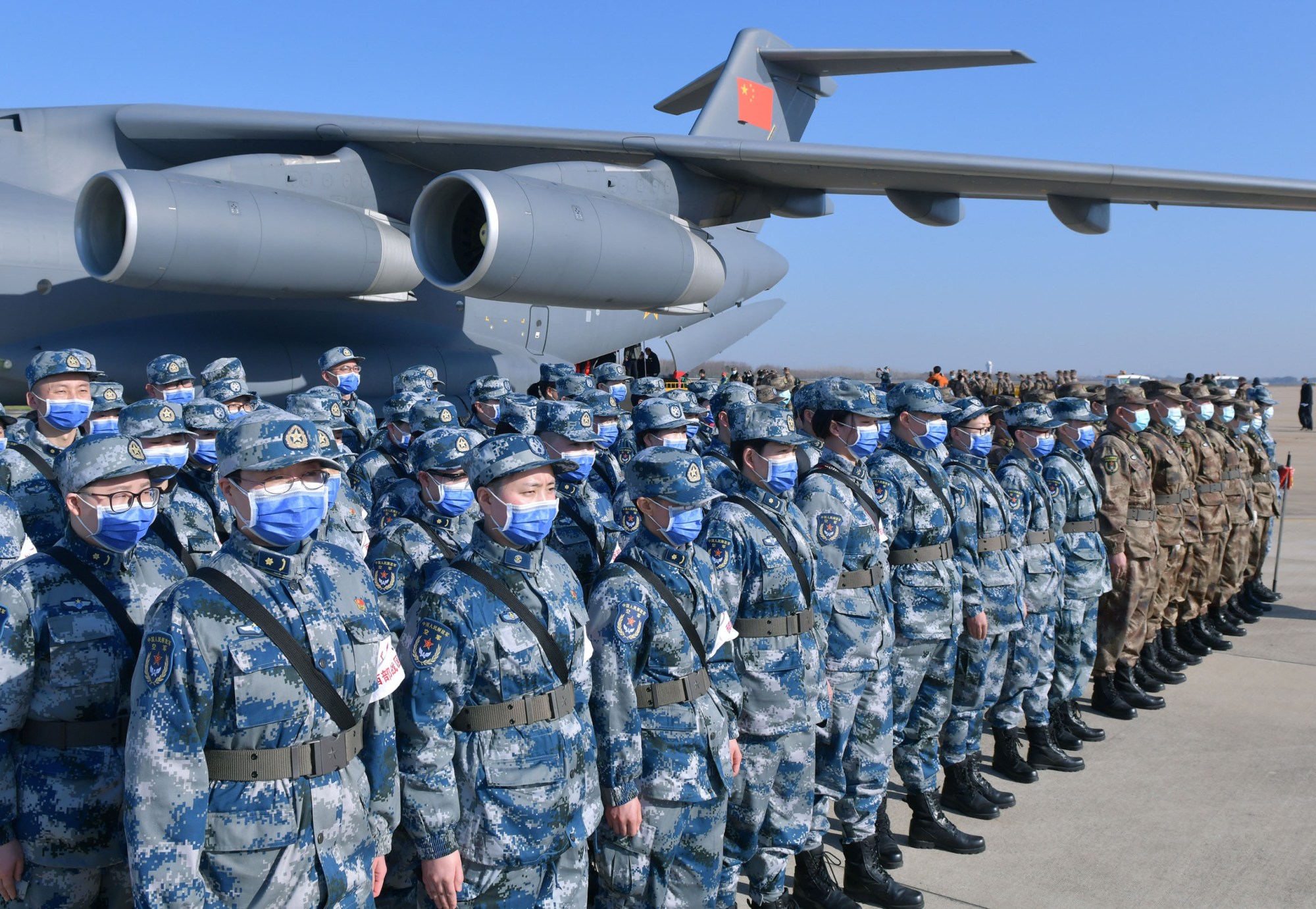 Military medics stand in formation after deplaning a transport aircraft at Tianhe International Airport in Wuhan, China, on February 17, 2020. (Getty/Li He)