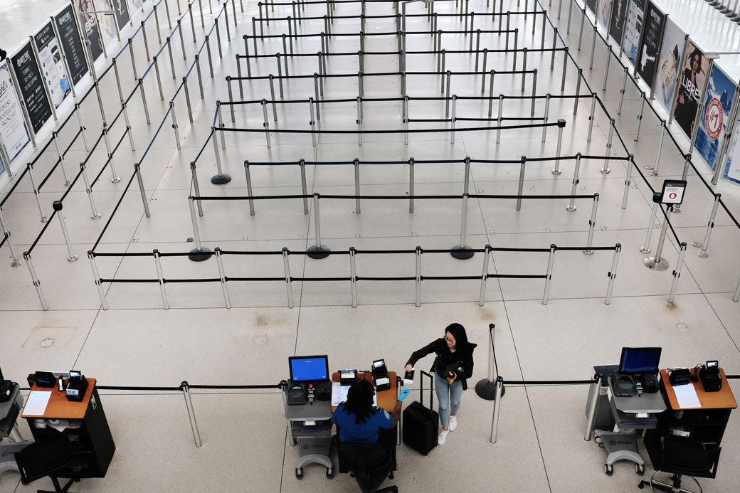 People walk through a sparse international departure terminal at John F. Kennedy Airport as concern over the coronavirus grows on March 7, 2020, in New York City. (Getty/Spencer Platt)