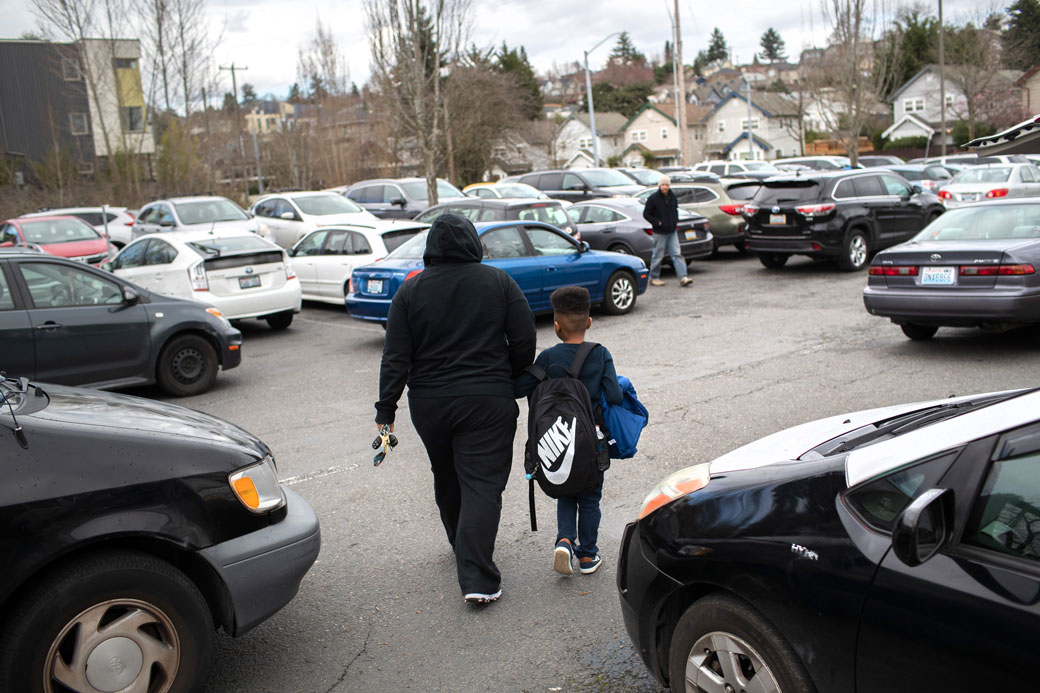 A student leaves elementary school with a parent after the Seattle Public School system was closed abruptly due to coronavirus fears on March 11, 2020. (Getty/John Moore)
