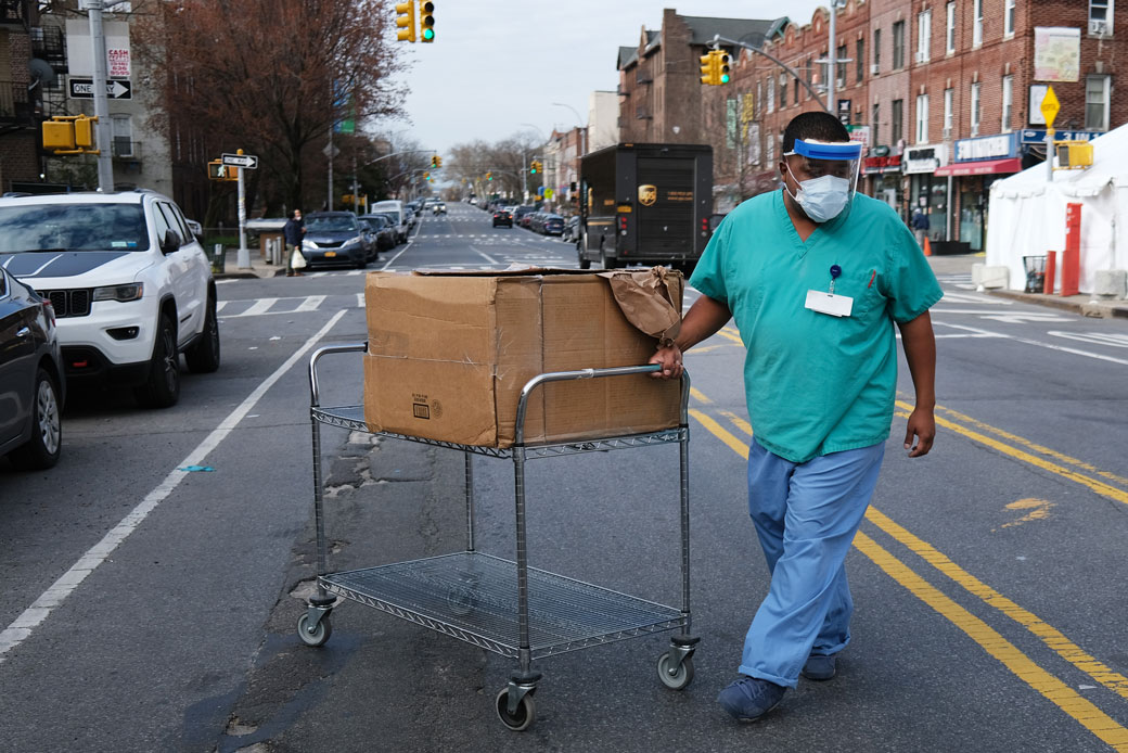 A medical worker walks outside of a special COVID-19 intake area at Maimonides Medical Center in New York City, April 2020. (Getty/Spencer Platt)