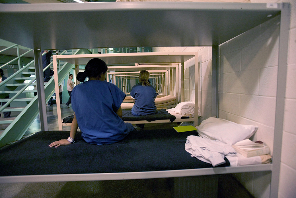Detainees sit on their beds in a privately run 1,000 bed detention center, February 2006, in Otay Mesa, California. (Getty/Robert Nickelsberg)