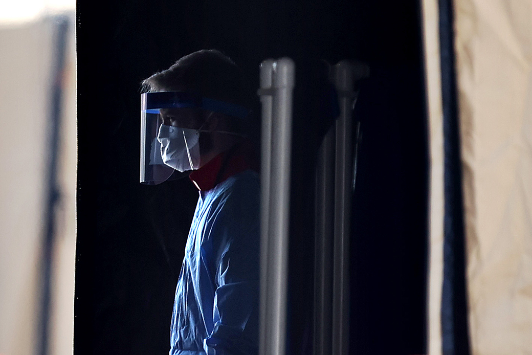 A health care professional prepares to screen people for the coronavirus at a testing site erected by the Maryland National Guard in a parking lot in Landover, Maryland, March 30, 2020. (Getty/Chip Somodevilla)