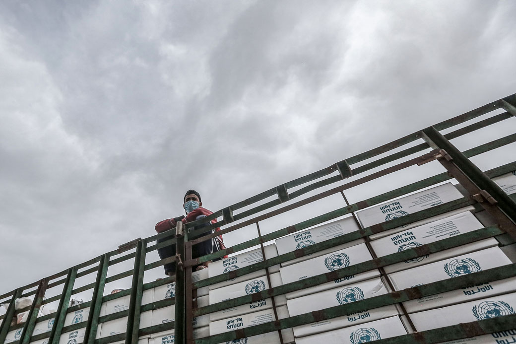 Employees of the United Nations Relief and Works Agency for Palestine Refugees in the Near East divide food aid rations for refugee families in Gaza, March 21, 2020. (Getty/Mohammed Talatene)