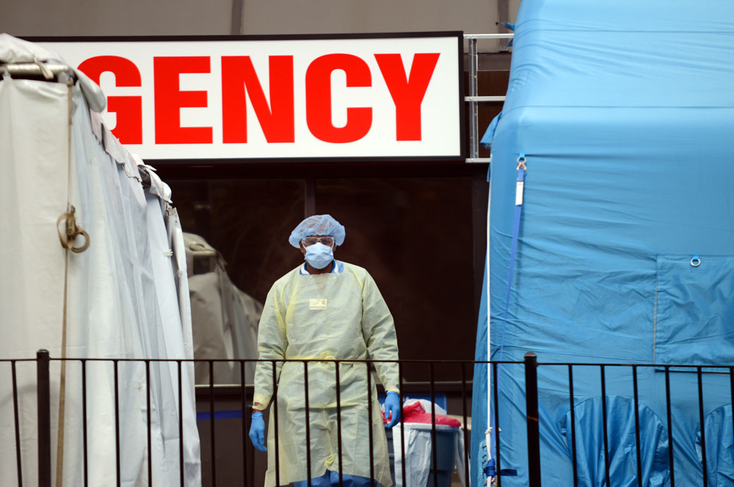 A doctor stands in the middle of the makeshift COVID-19 screening center outside Elmhurst Hospital in Queens, New York, April 2020. (Getty/B.A. Van Sise)