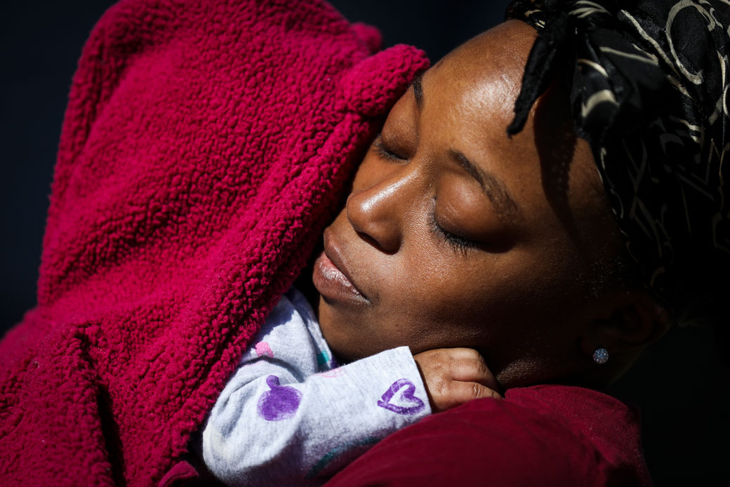 A mother comforts her 2-month-old daughter in Medford, Massachusetts, on March 27, 2020. (Getty/Erin Clark/The Boston Globe)