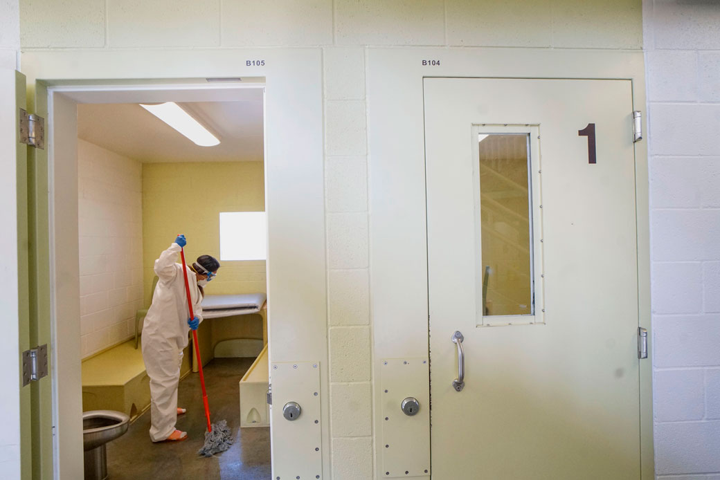 An inmate cleans a jail cell at a women's detention facility in Santee, California, on April 22, 2020. (Getty/Sandy Huffaker/AFP)