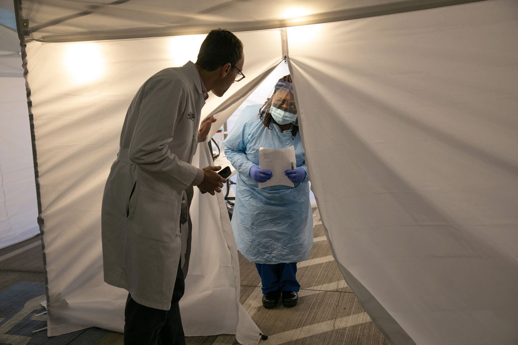 A doctor and nurse converse before testing patients for the coronavirus at the University of Washington Medical Center on March 13, 2020, in Seattle. (Getty/John Moore)