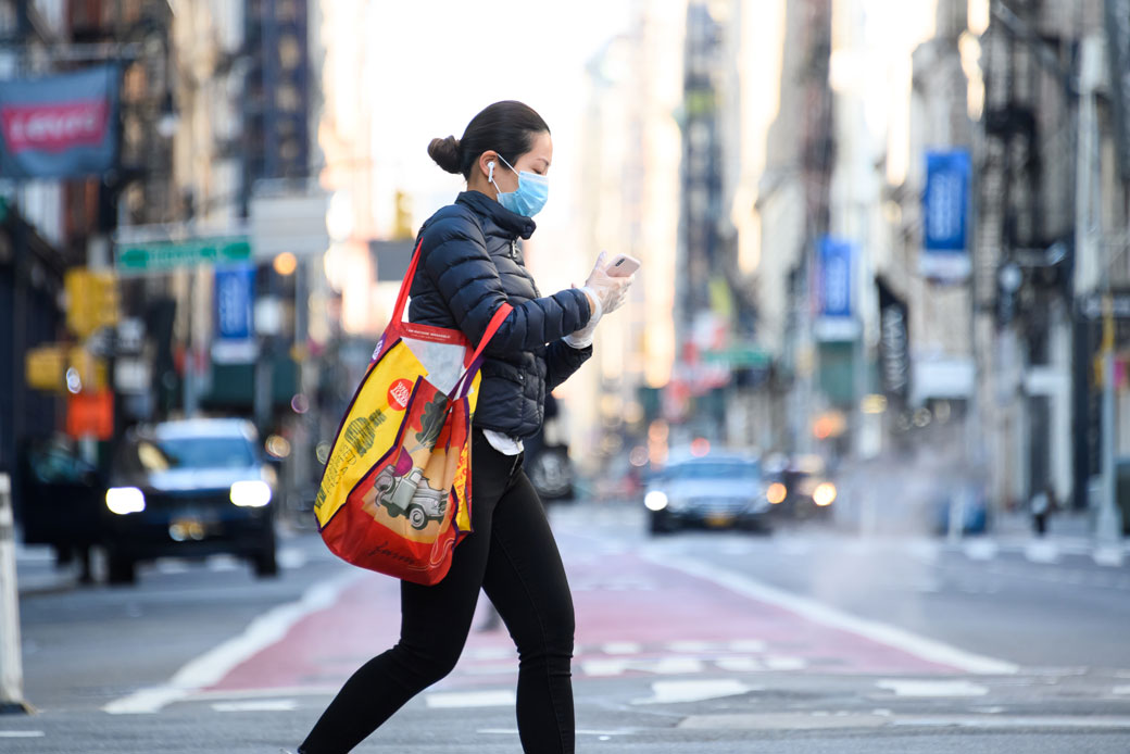 A person wearing a face mask crosses the street in New York City on April 15, 2020. (Getty/Noam Galai)